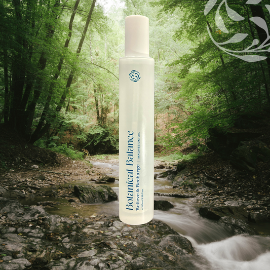 Bottle of Botanical Balance product in a forest setting with a stream.
