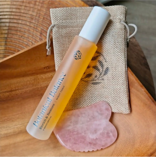 Rose Quartz Gua Sha stone close up — natural facial ritual tool for perimenopause and menopause skin support