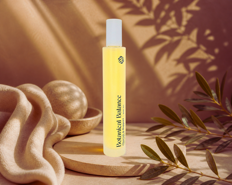 Yellow bottle labeled 'Botanical Balance' on a wooden surface with a natural background