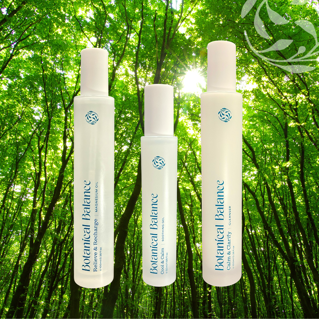 Three Botanical Balance bottles against a green forest background