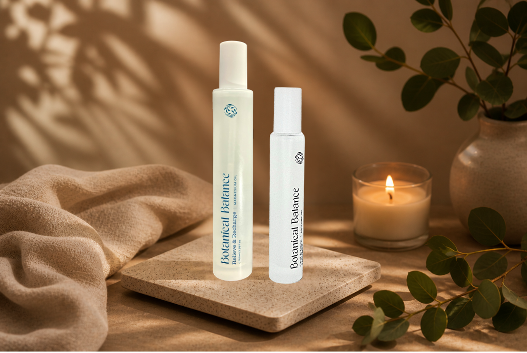 Two skincare bottles on a wooden surface with a candle and plant in the background